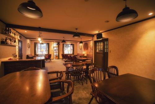a restaurant with tables and chairs in a room at Umitoyama Hakuba in Hakuba