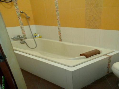 a bathroom with a bath tub with a towel on it at Seventeen homestay in Bandung