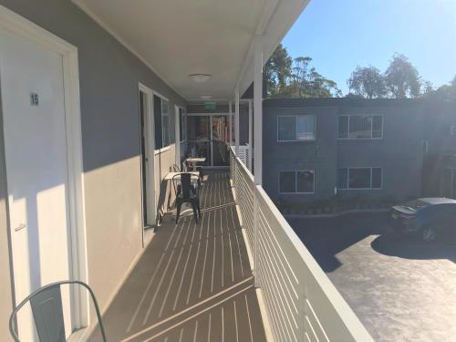a balcony of a house with a table on it at Toukley Motor Inn in Toukley