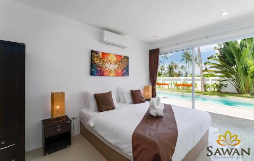 a bedroom with a bed and a swimming pool at SAWAN Residence Pool Villas in Lamai
