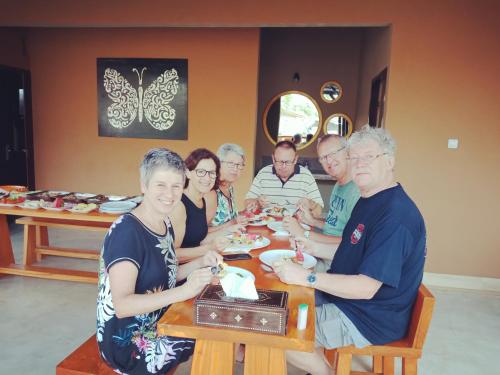 a group of people sitting at a table eating at ZiFa Mandalika in Kuta Lombok