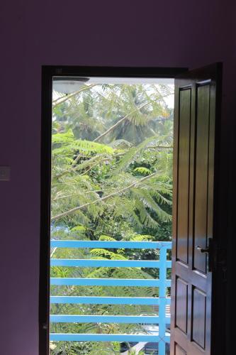 an open door with a view of a tree at Puthenchirayil Homestay in Trivandrum