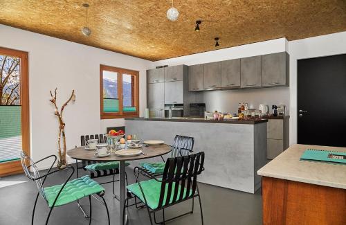 a kitchen with a table and chairs in a room at B&B La Forge de Diogne in Crans-Montana