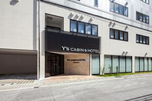 a building with a sign on the front of it at Y's CABIN&HOTEL Naha Kokusai Street in Naha