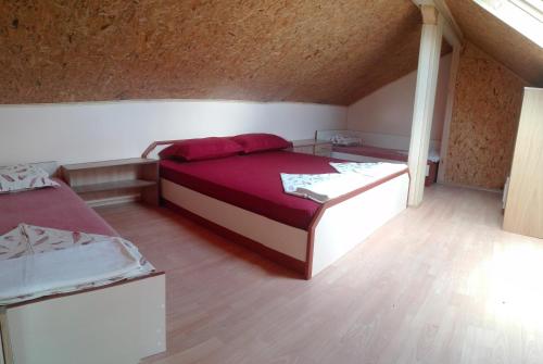 a bedroom with two beds in a attic at Eleonor Guest House in Byala