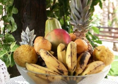 a bowl of fruits and vegetables on a table at Pousada Bangalô in Jericoacoara