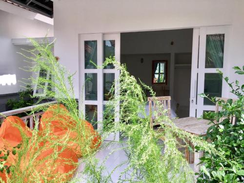 a front porch of a house with plants at Narayana Homestay in Amed