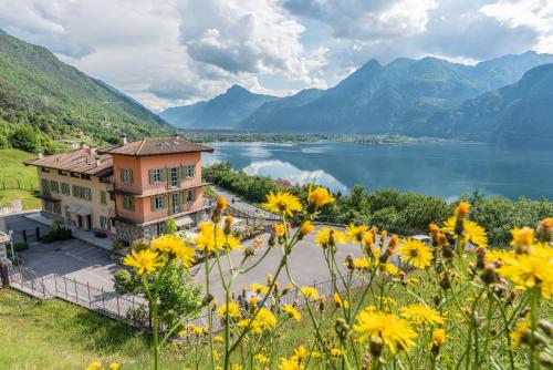 a house with a view of a lake and mountains at Garden View in Anfo