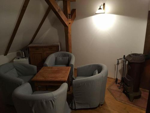a room with chairs and a table and a light at Bučický mlýn in Rožďalovice