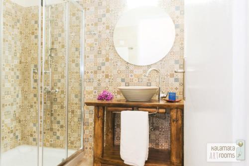 a bathroom with a sink and a shower at Kalamata Art Rooms in Kalamata