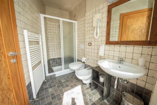 a bathroom with a sink and a toilet at Garden View in Anfo