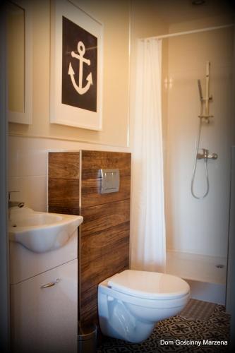 a bathroom with a sink and a toilet and a shower at Dom Gościnny Marzena in Międzyzdroje