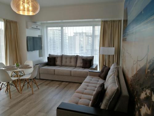 ママイアにあるDelos Apartment With Sea Viewのリビングルーム(ソファ、テーブル付)