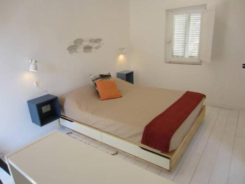 a bedroom with a bed and a tv on the floor at Villa Lina B&B in San Felice Circeo
