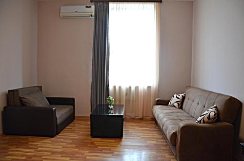 a living room with a couch and a chair at Giansa in Tbilisi City