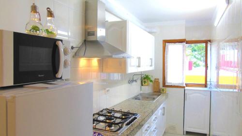 a white kitchen with a refrigerator and a sink at Apt. Lourdes, close to the Teresitas & Anaga in El Roque