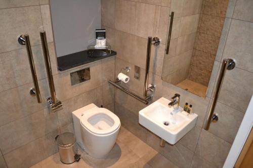 a bathroom with a toilet and a sink at Auchrannie Resort in Brodick