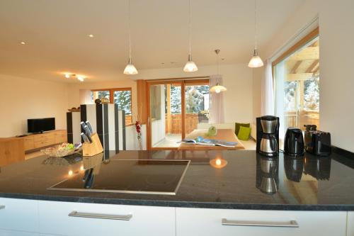 a kitchen with a counter top with a refrigerator at Apartmenthaus Fuchsmaurer in Bressanone