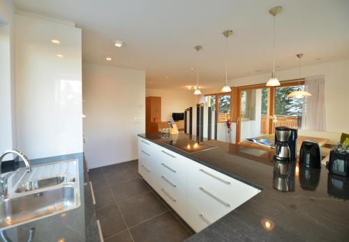 a kitchen with white cabinets and a counter top at Apartmenthaus Fuchsmaurer in Bressanone