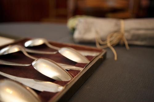 a tray with silver spoons on a table at Boutique & Gourmet Hotel Orso Grigio in San Candido