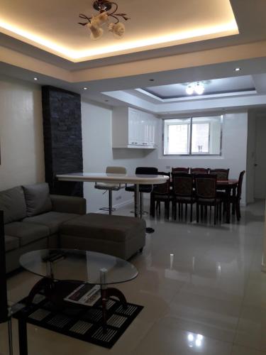 a living room with a couch and a table at Golden Queen Suites in Baguio