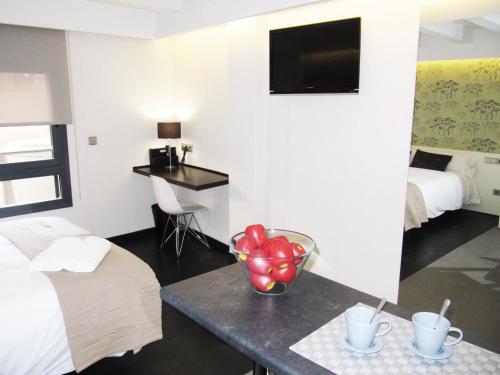 a hotel room with a table with apples on it at Barcelona Fifteen central Aparthotel in Barcelona