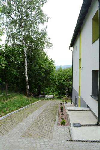 a cobblestone street next to a white building at Guest House at Lesya Ukrainka in Truskavets