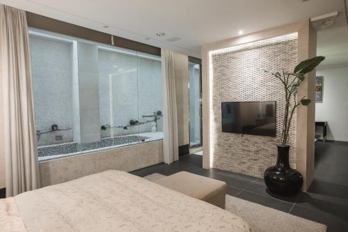 a bedroom with a tub and a television in a room at Motel Stars in Taichung
