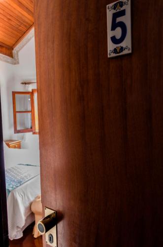 a door to a bedroom with a number five on it at Pousada Casa Da Colina in Santo Antônio do Pinhal