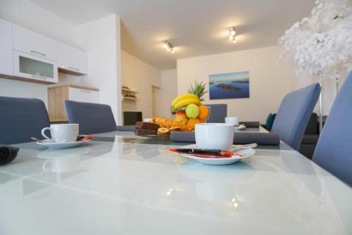 a table with a bowl of fruit on top of it at TJ Apartment 2 Zadar in Zadar