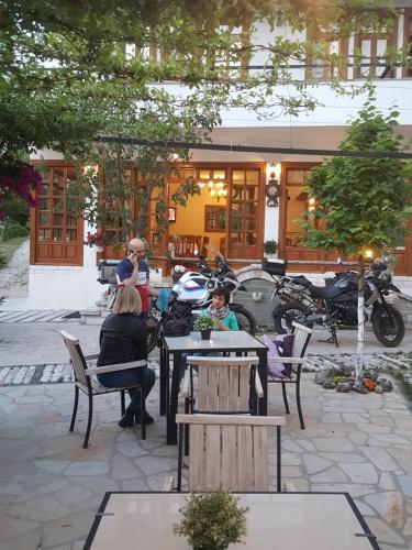 a large group of people sitting around a table at Hotel Gjirokastra in Gjirokastër