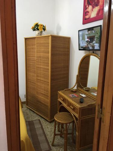 a room with a dresser and a mirror and a desk at Holiday Home Gionny & Mary in Taormina