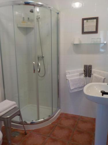 a bathroom with a glass shower and a sink at Posada Tresvalle in Ubiarco