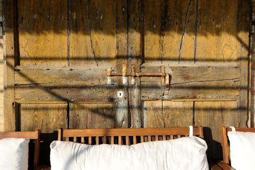 a wooden wall with a bed in front of it at Relais Del Lago in Capannori