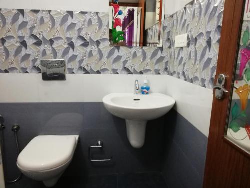 a bathroom with a sink and a toilet at Takashi Homestay North Paravur Near Muziris in North Paravur