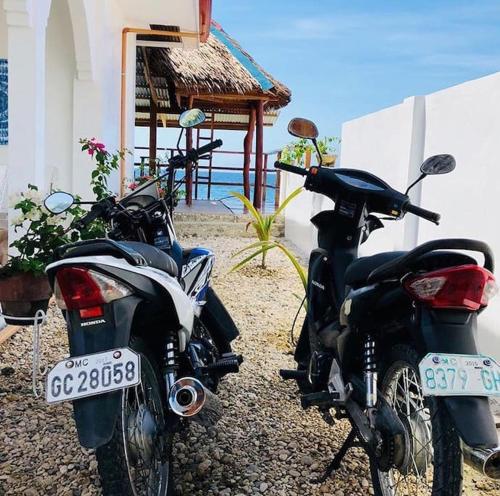 two motorcycles parked in front of a building at Costa Cantagay in Jagna