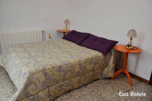 a bedroom with a bed and two lamps on tables at Casa Victoria 2 in La Vilella Baixa