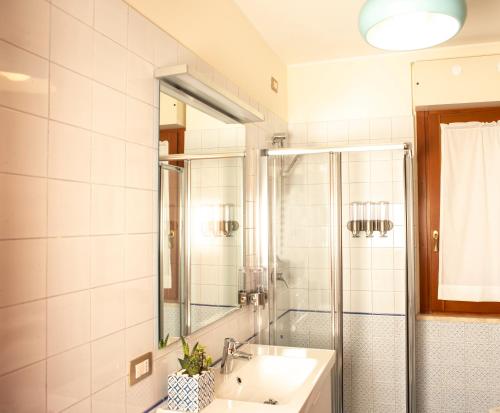 a bathroom with a sink and a shower at Lalaland Apartment in Cagliari