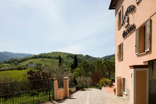 a building with a fence next to a road at Albergo Villa Cristina in Spoleto