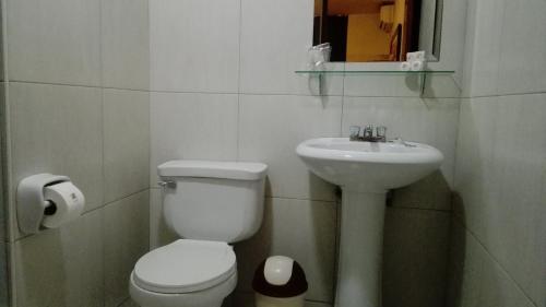 a bathroom with a toilet and a sink at My Rouse Hotel in Chiclayo