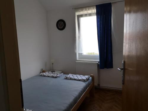 a bedroom with a bed in a room with a window at Plaža in Sremska Mitrovica