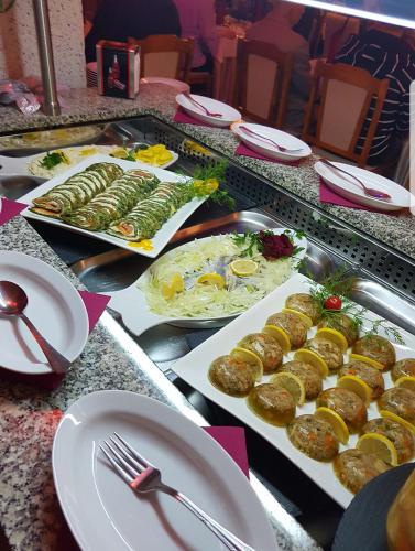 a buffet with plates of food on a table at Eva in Mrągowo