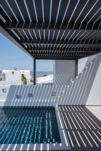 a swimming pool on the roof of a house at Valery Suites in Fira