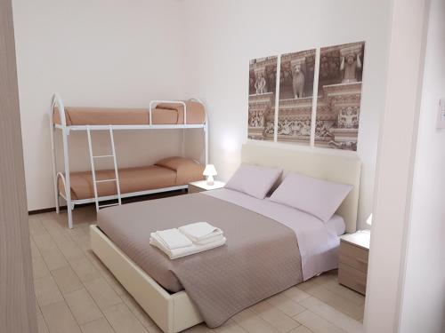 a bedroom with a bed and a bunk bed at Case Vacanza Via Mozart in Porto Cesareo