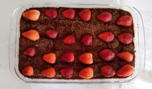 a chocolate cake with strawberries on top in a pan at Pousada Berço da Liberdade in Tiradentes