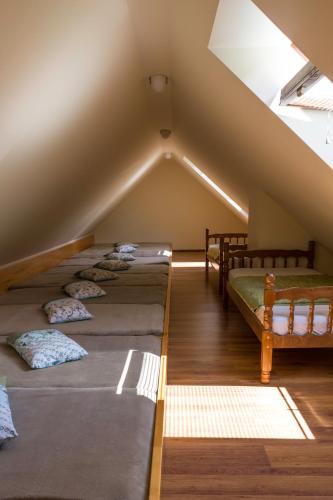 a attic with four beds in a room at Turistična Kmetija Toman in Gornji Grad