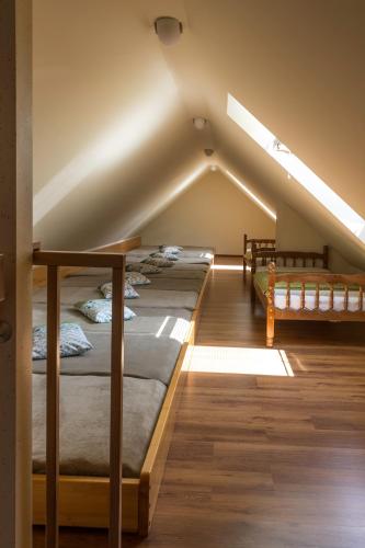 a attic bedroom with four bunk beds in it at Turistična Kmetija Toman in Gornji Grad