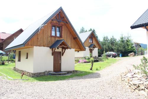 a small house with a wooden roof at Sielski Zakątek in Cisna