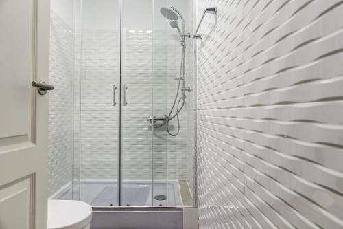 a bathroom with a glass shower with a toilet at Hostel Seven Hills in Lisbon