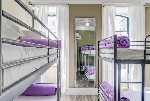 a bunk room with purple bunk beds and a staircase at Hostel Seven Hills in Lisbon